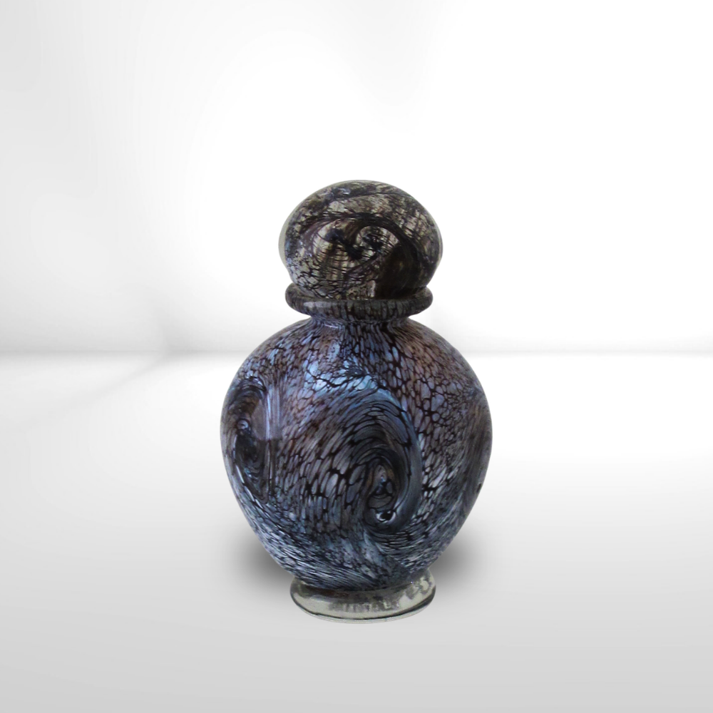Glass-blown perfume bottle with black swirls