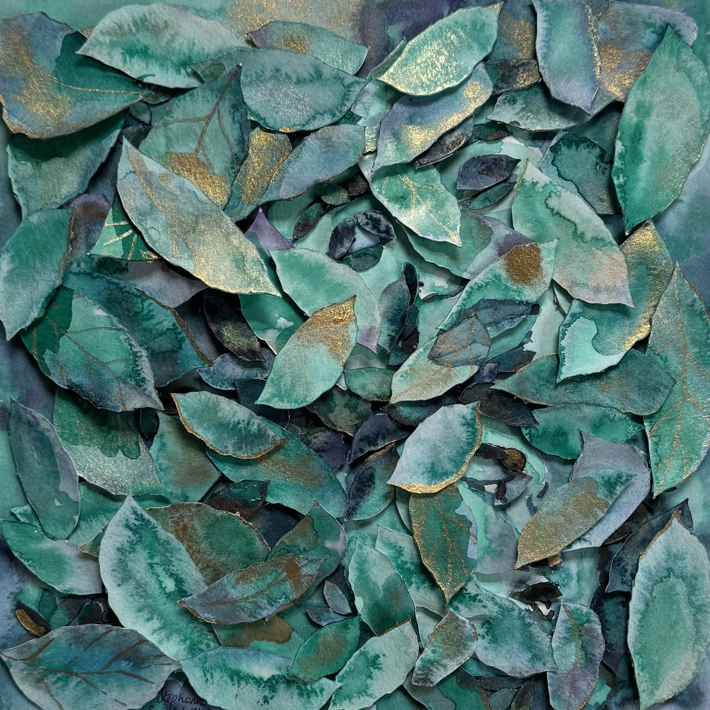 watercolor leaves cut out and layered on canvas