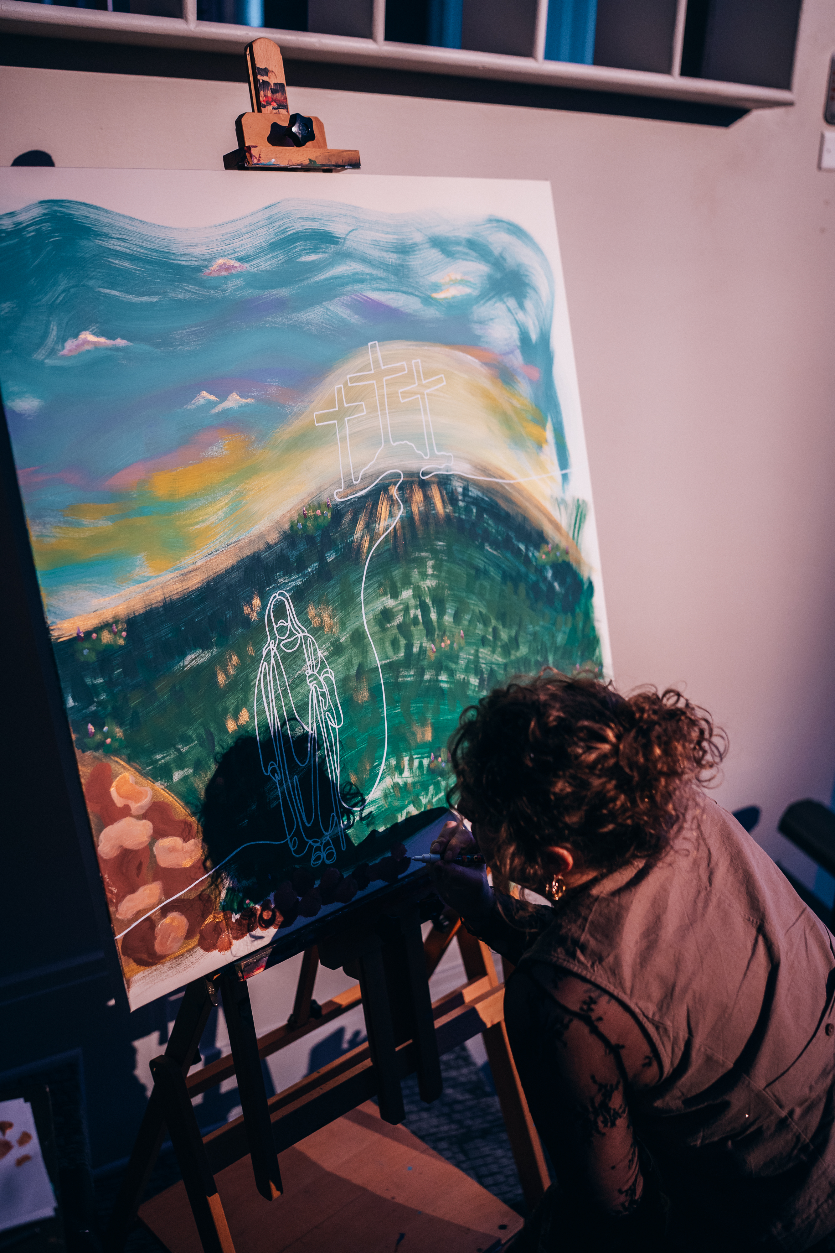 woman painting a grassy field