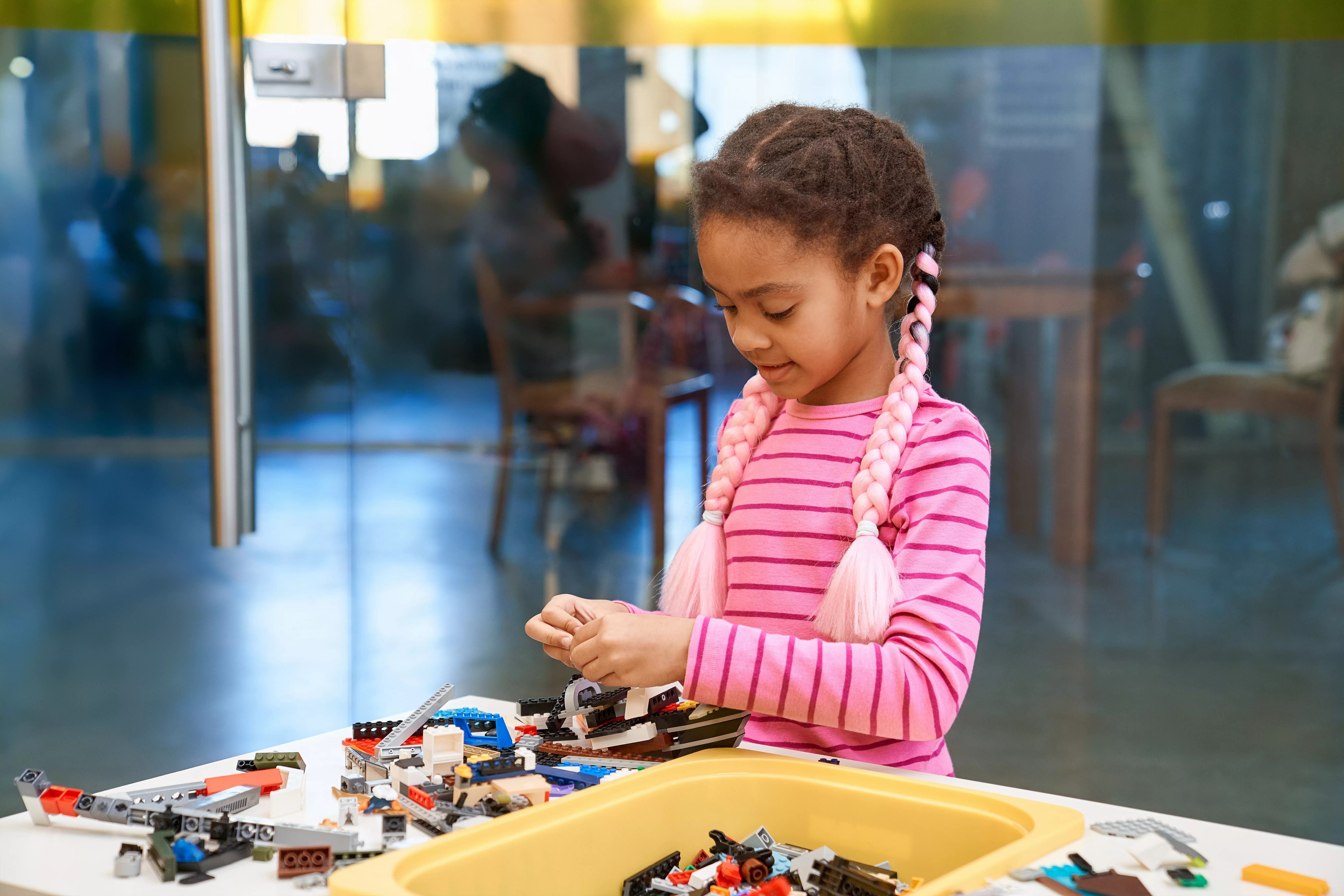 African American young girl playing with legos